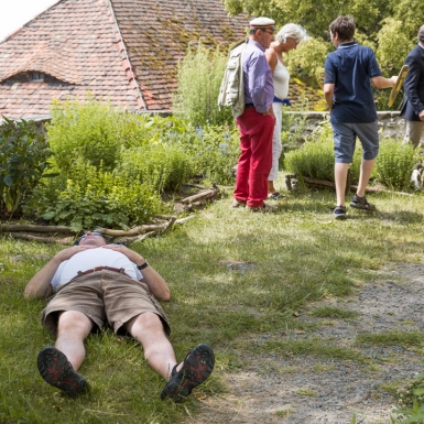 Burschenschafter genießt das gute Wetter im Kräutergarten der Leuchtenburg.
